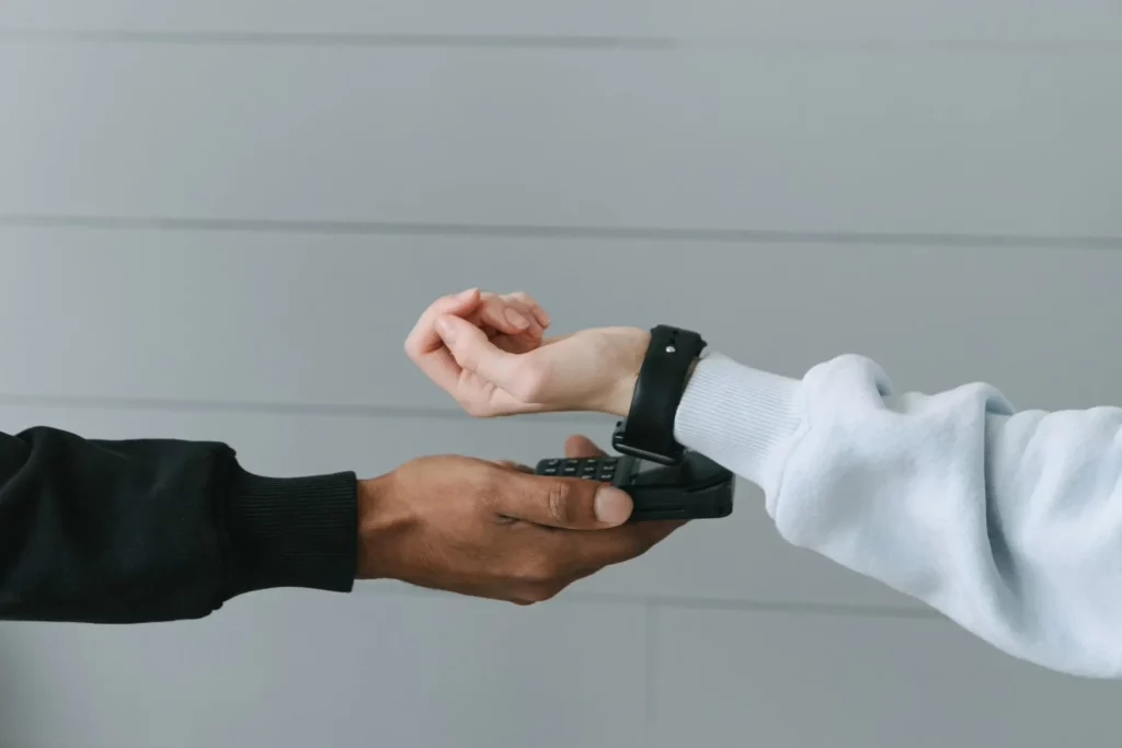 a shopper paying via a smart watch